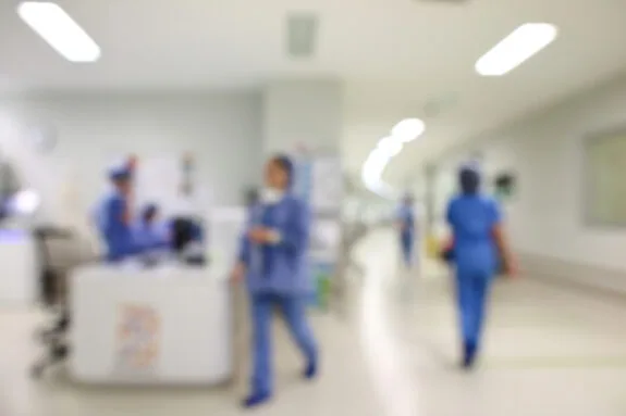 Blurry background of a hospital with nurses and physicians