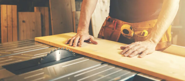 cutting wooden board on a table saw. woodworking and carpentry. furniture manufacturing