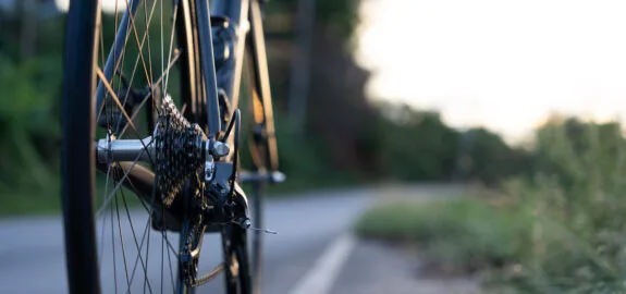 Road bike parked on a beautiful road sunset, warm light with copy space.